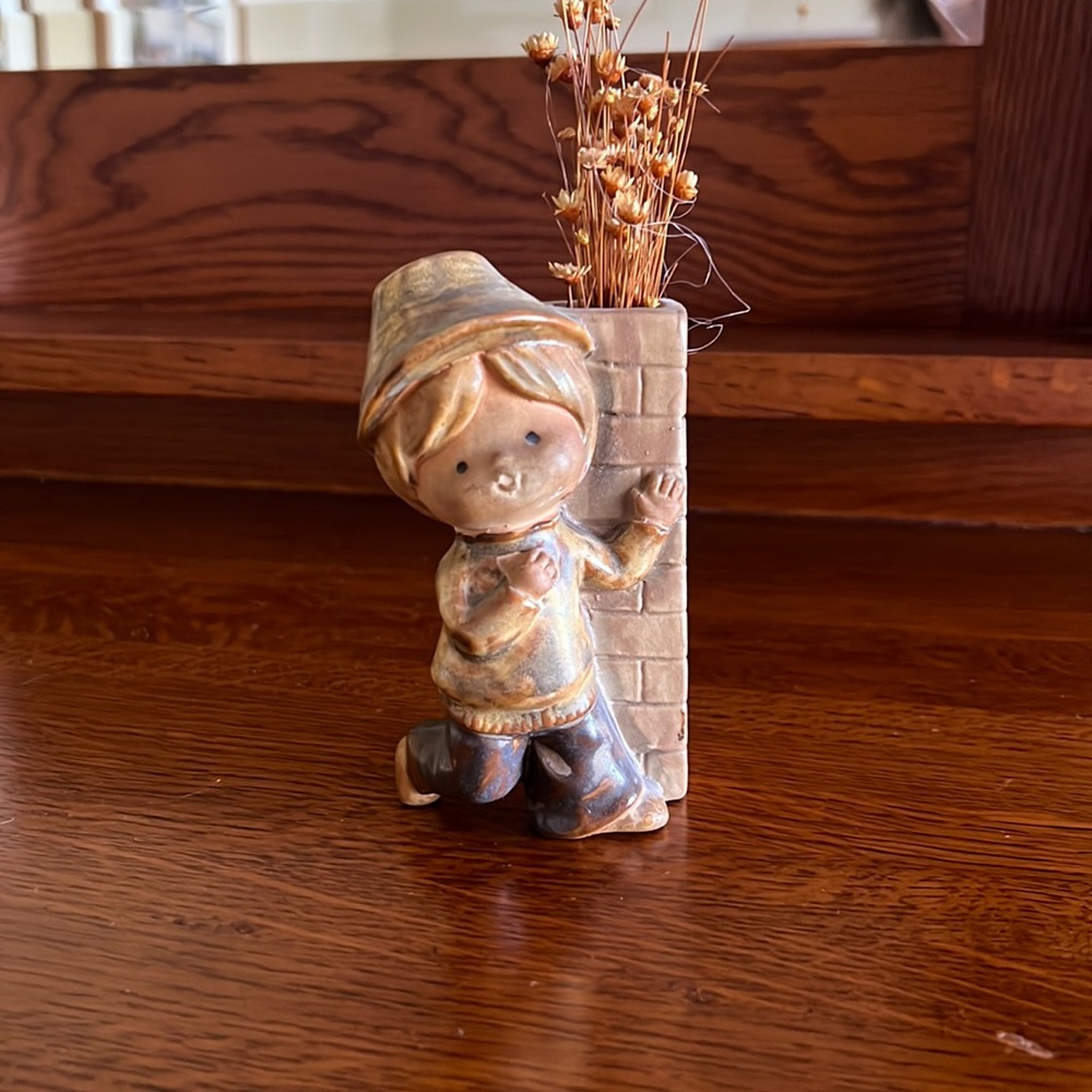 Boy figurine with small vase